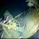 Fish swim around the helm of the sunken sub. (Australian Department of Defense via AP)